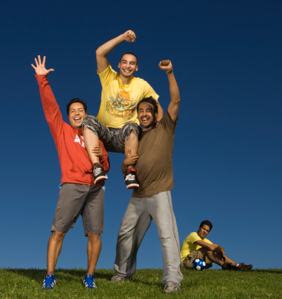 Men celebrating after soccer match